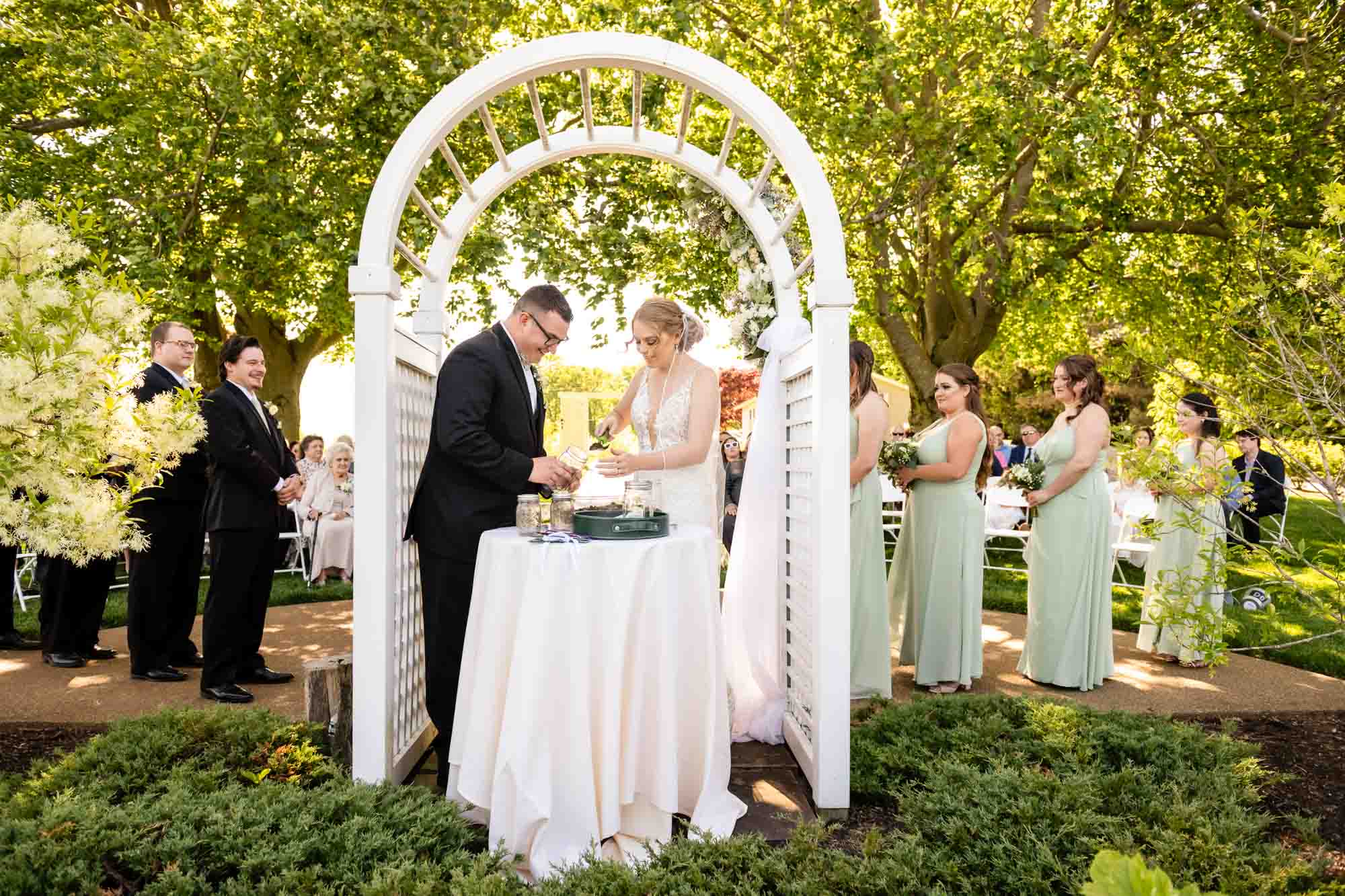 bride and groom plant a tree together in honor of their marriage